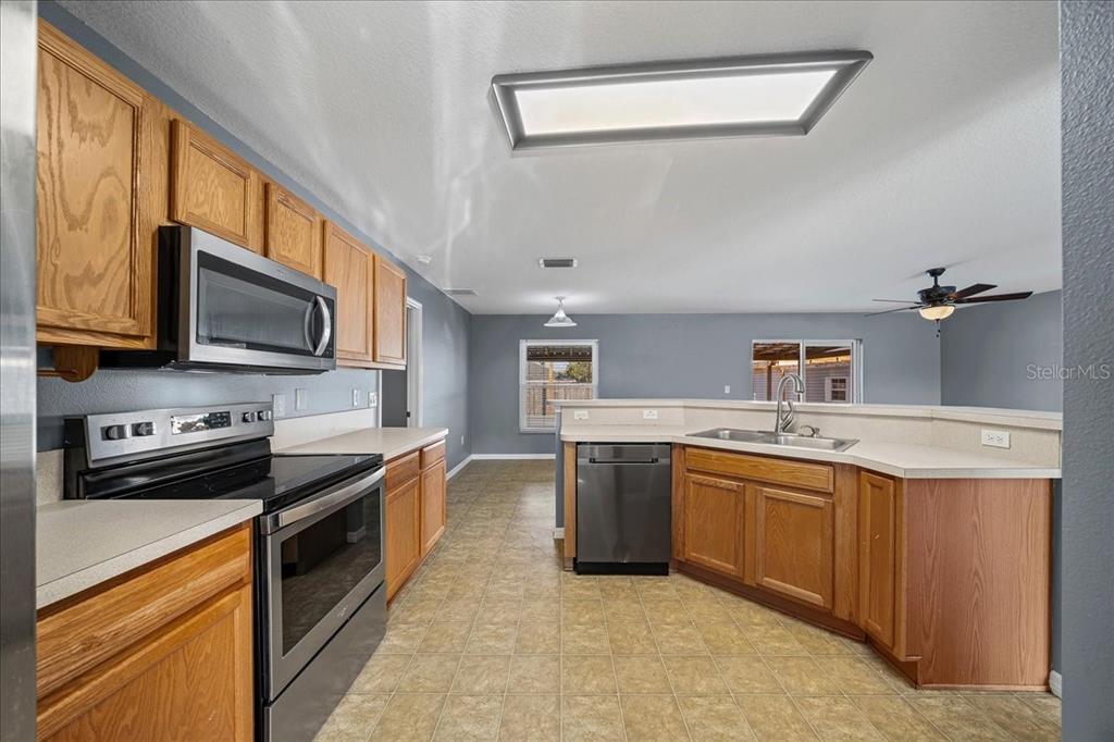 155 Juniper Way Ocala, FL 34480 - Photo 10 of 67 a kitchen with stainless steel appliances granite countertop a sink stove oven and granite counter top