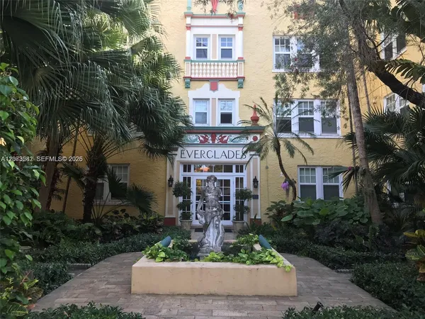 a view of a building with garden and trees