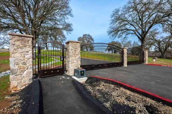 a view of a park with iron fence