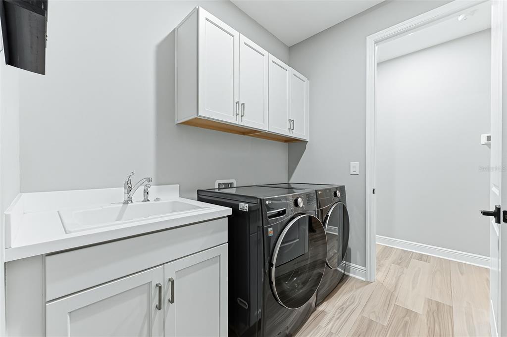 4191 Pegasus Way Naples, FL 34120 - Photo 32 of 48 a utility room with sink dryer and washer