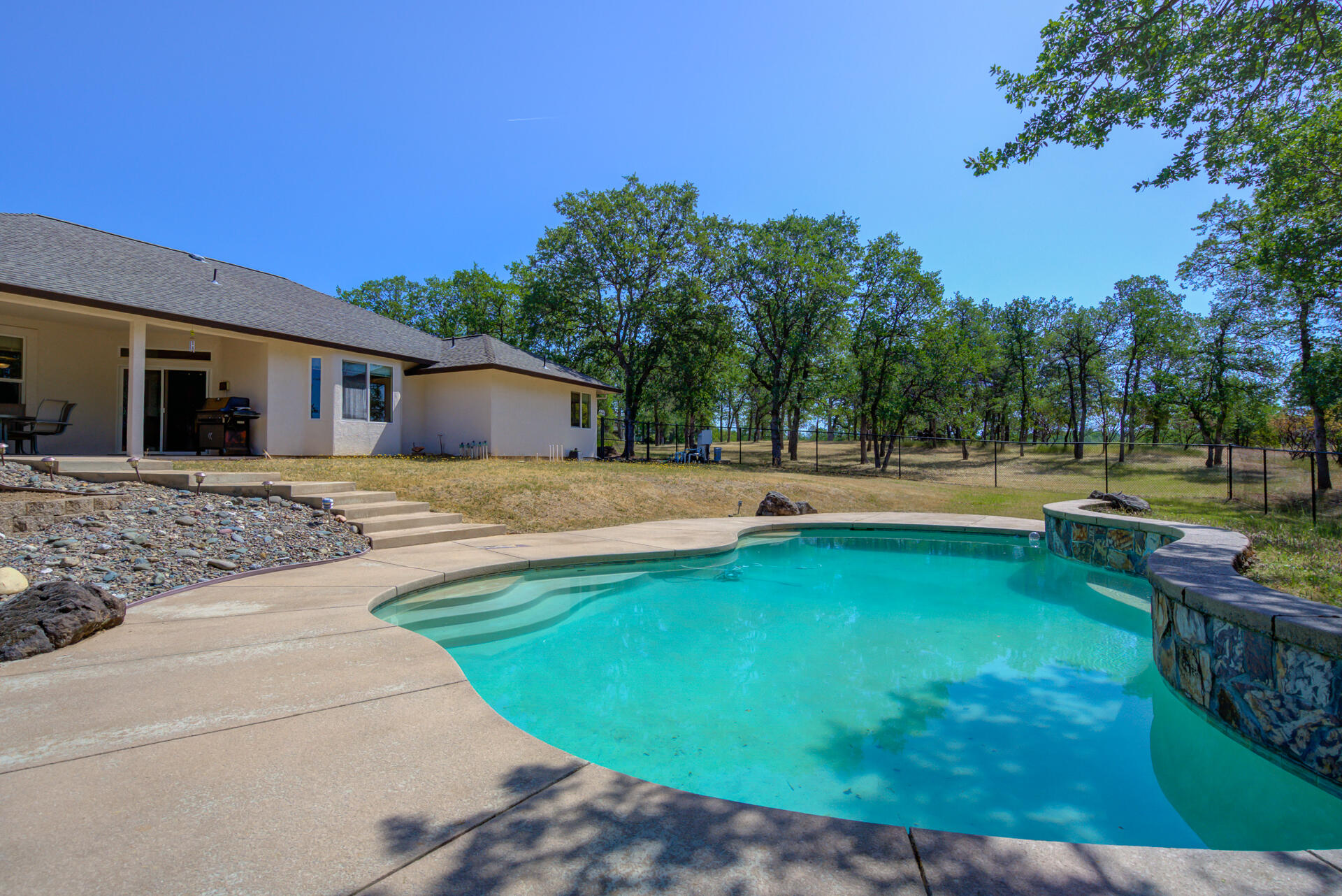 13223 Padani Drive Redding, CA 96003 - Photo 3 of 48 a view of a house with swimming pool and yard