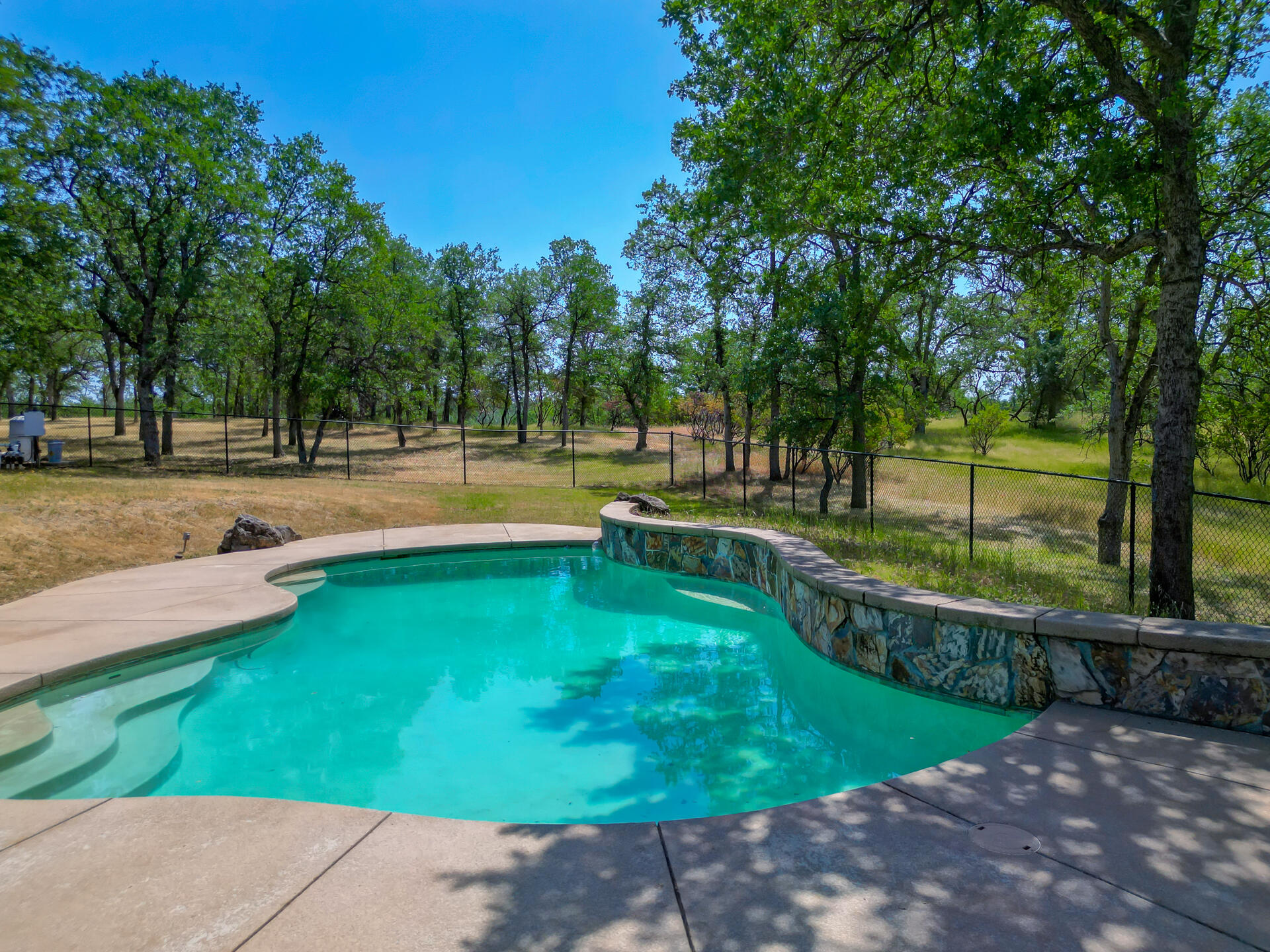 13223 Padani Drive Redding, CA 96003 - Photo 33 of 48 a view of a swimming pool with a yard and sitting area
