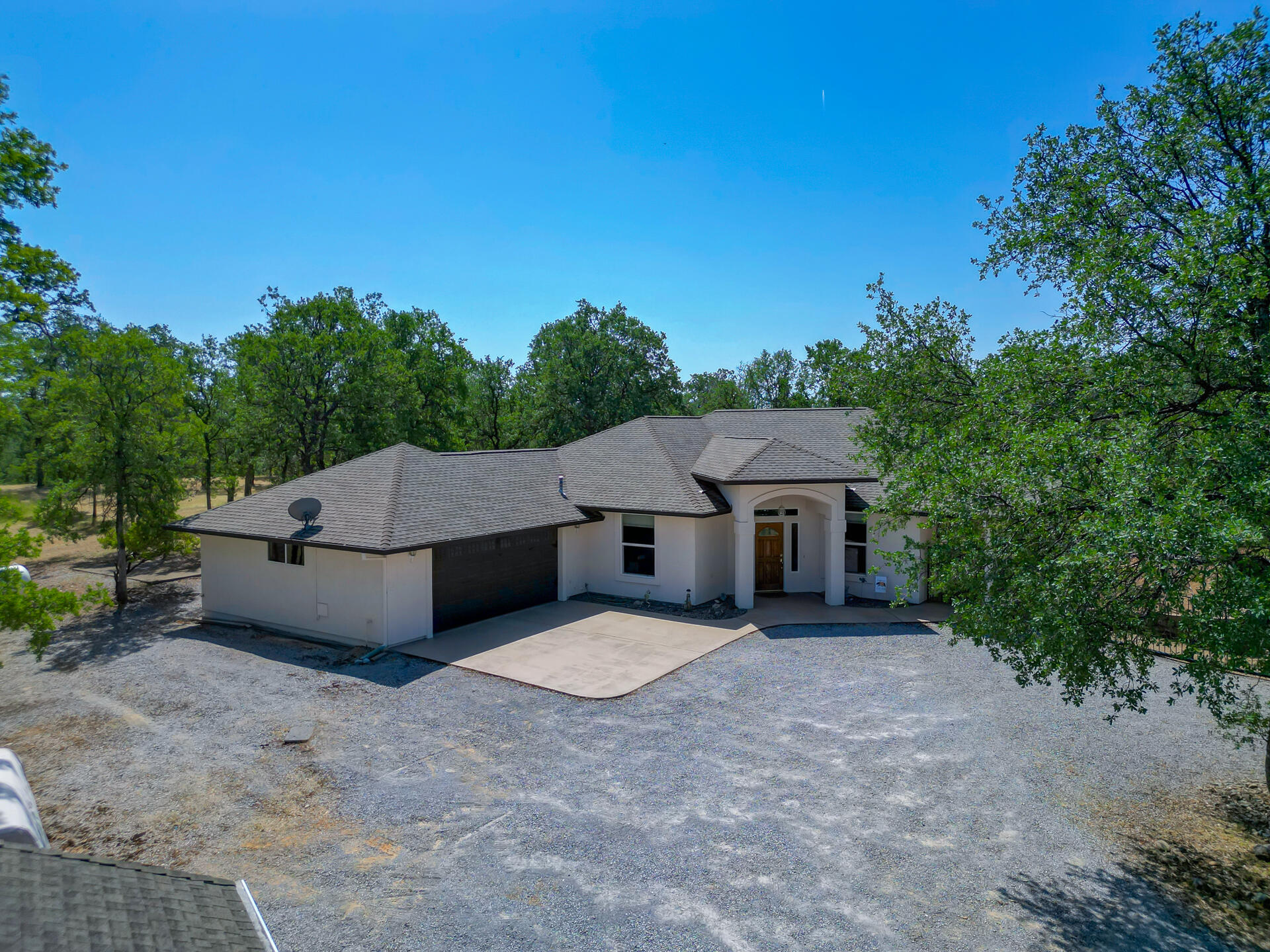 13223 Padani Drive Redding, CA 96003 - Photo 39 of 48 a house with trees in the background