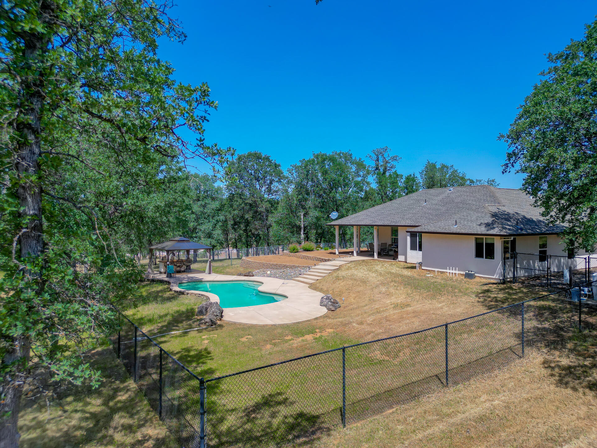 13223 Padani Drive Redding, CA 96003 - Photo 46 of 48 a view of a house with backyard and sitting area