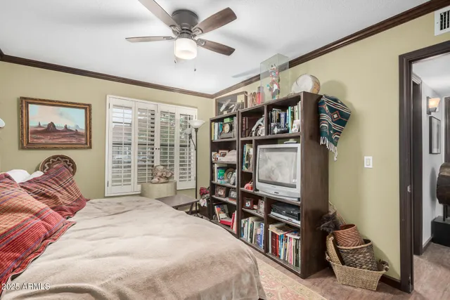 a bedroom with a bed dresser and a window