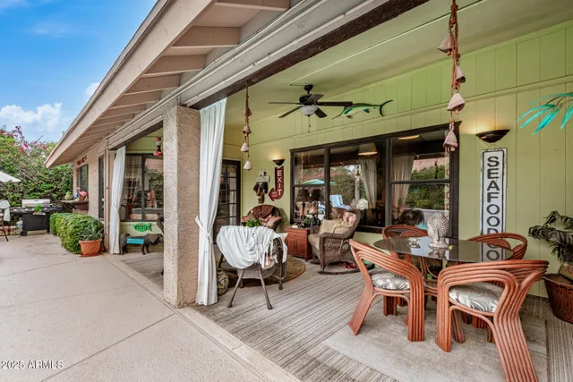 a view of a patio with a table and chairs and potted plants