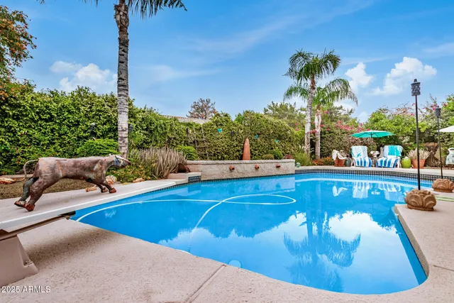 a view of a swimming pool with outdoor seating