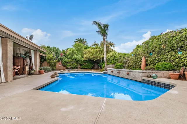 a view of a swimming pool and trees in the background