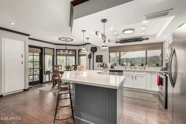 a large white kitchen with a large window