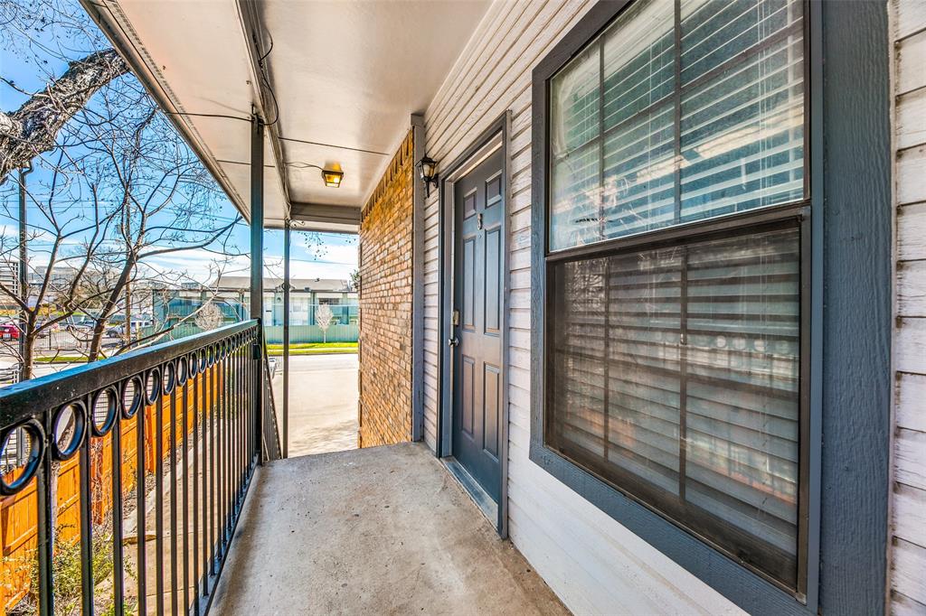 2815 Reagan Street Dallas, TX 75219 - Photo 21 of 40 a view of a balcony with wooden floor and iron stairs