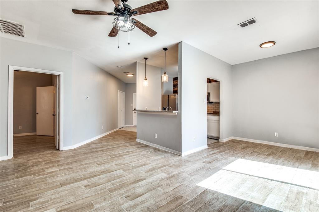 2815 Reagan Street Dallas, TX 75219 - Photo 22 of 40 a view of empty room with wooden floor and ceiling fan