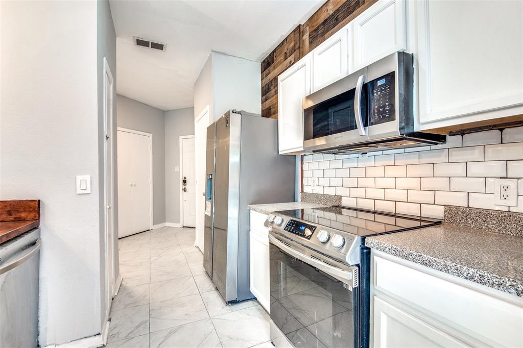 2815 Reagan Street Dallas, TX 75219 - Photo 24 of 40 a kitchen with a stove and a microwave