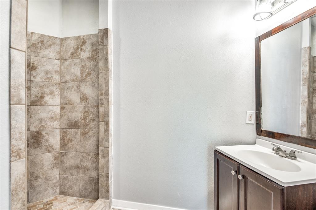 2815 Reagan Street Dallas, TX 75219 - Photo 26 of 40 a bathroom with a sink and a mirror