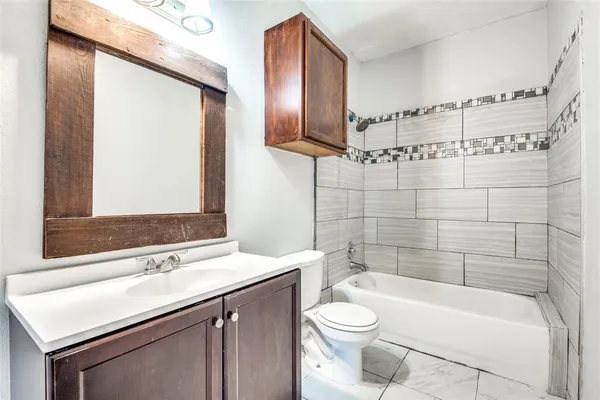 a kitchen with granite countertop a sink a counter space appliances and cabinets