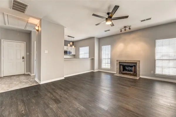 an empty room with wooden floor and closet