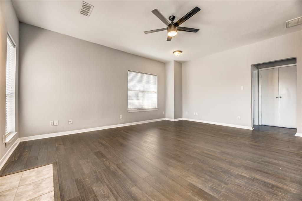 2815 Reagan Street Dallas, TX 75219 - Photo 33 of 40 an empty room with wooden floor and windows