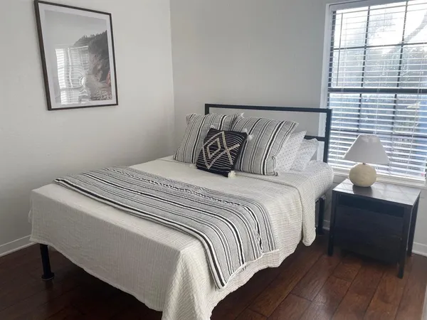 a bed room with a bed and a lamp with window