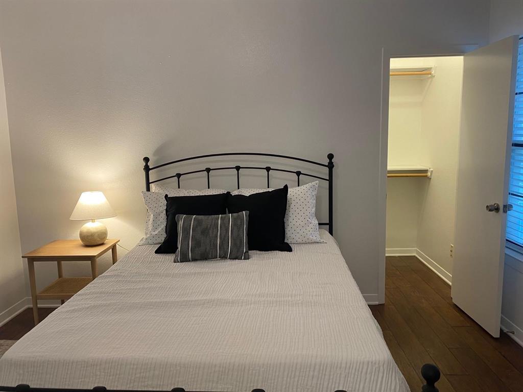 2815 Reagan Street Dallas, TX 75219 - Photo 39 of 40 a bed room with a bed and a lamp with window