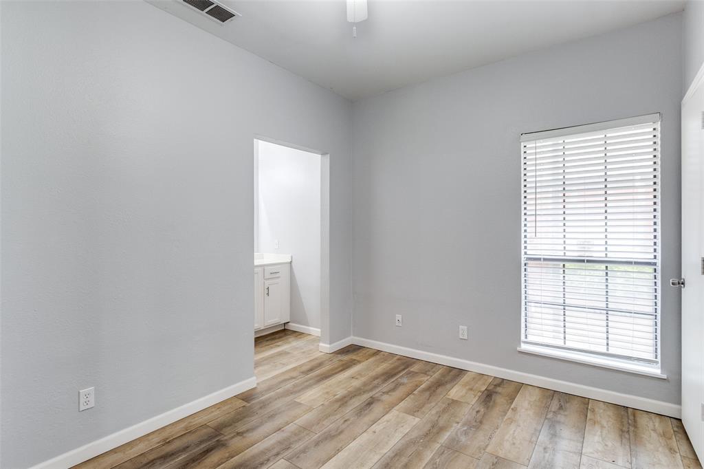 2815 Reagan Street Dallas, TX 75219 - Photo 6 of 40 an empty room with wooden floor and windows