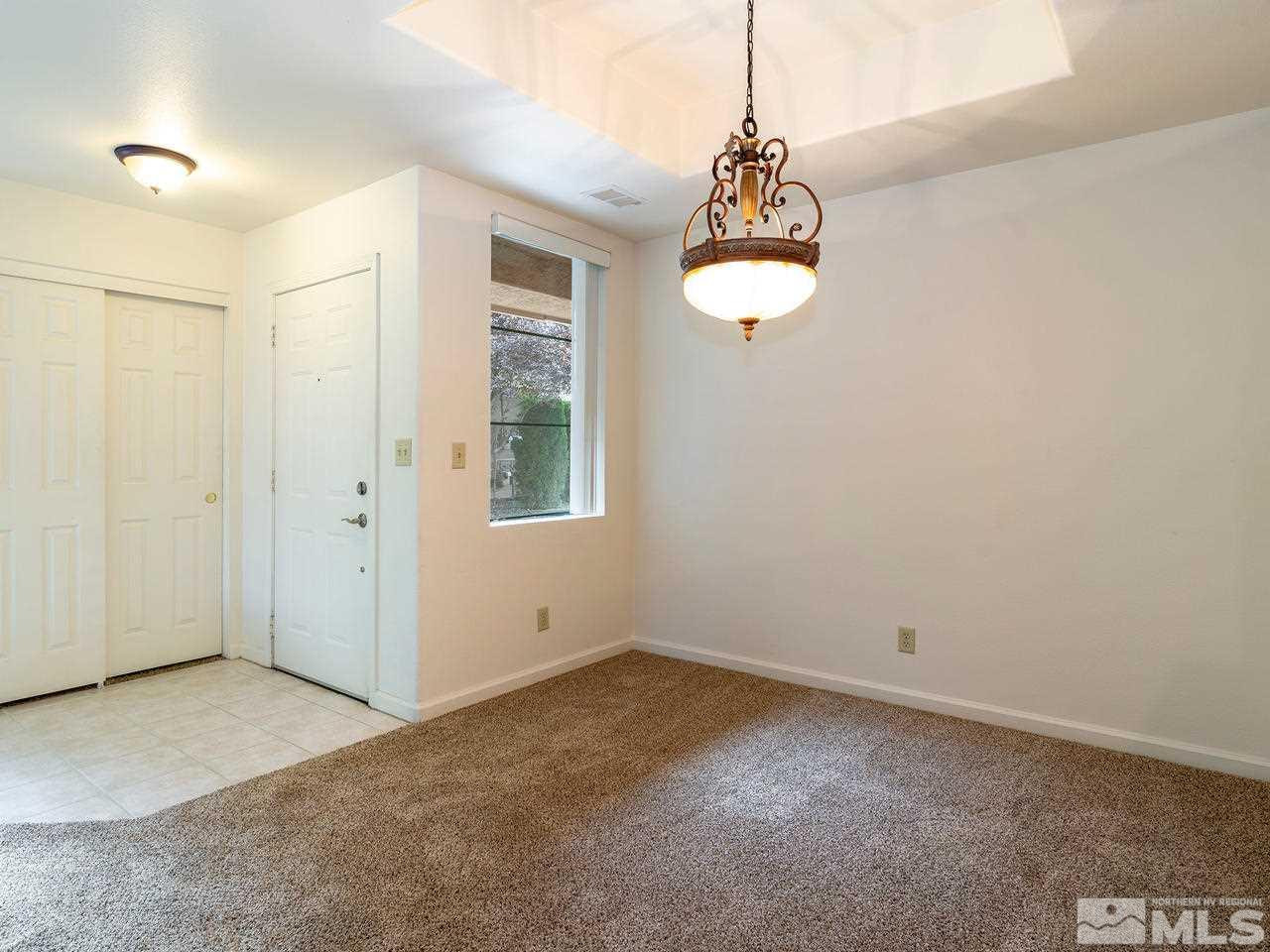 900 South, Unit 214 Reno, NV 89521 - Photo 4 of 22 an empty room with windows and chandelier