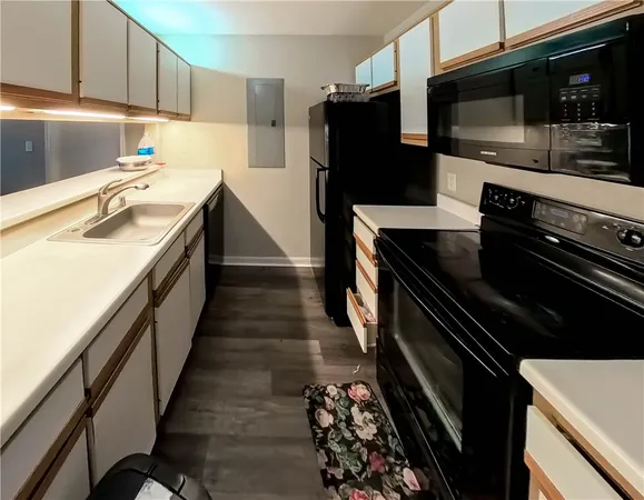 a kitchen with a sink stainless steel appliances and cabinets
