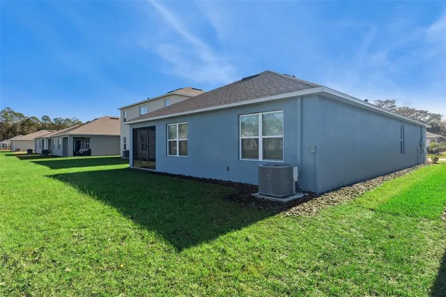a view of house with backyard