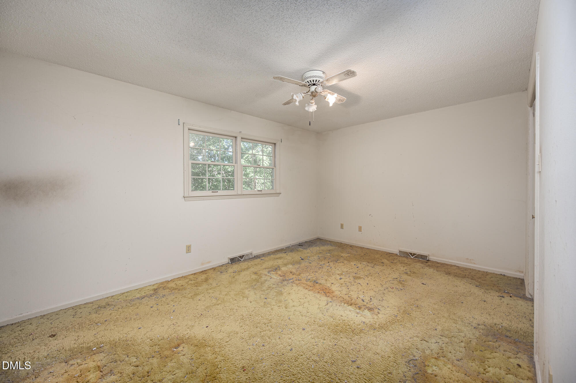 4411 Rhew Drive Durham, NC 27704 - Photo 23 of 34 an empty room with a fan & a window