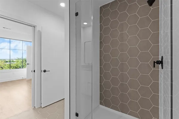 a bathroom with a granite countertop sink a mirror and shower