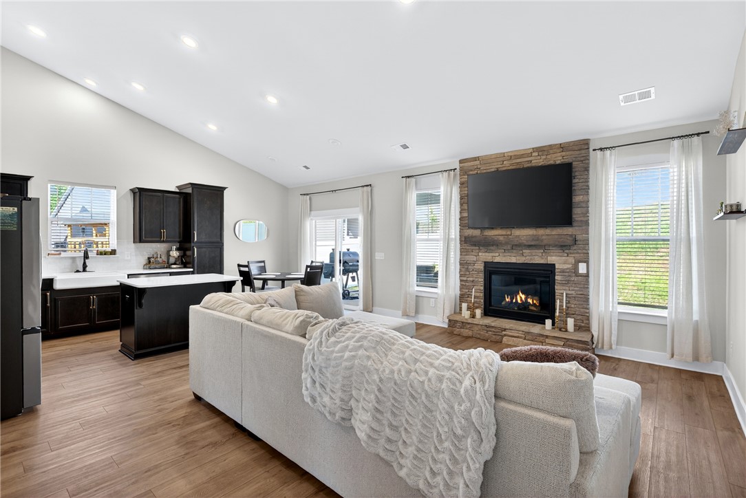 128 Whitman Way Easley, SC 29642 - Photo 2 of 34 This inviting space features a grand fireplace and ample natural light, perfect for gatherings.
