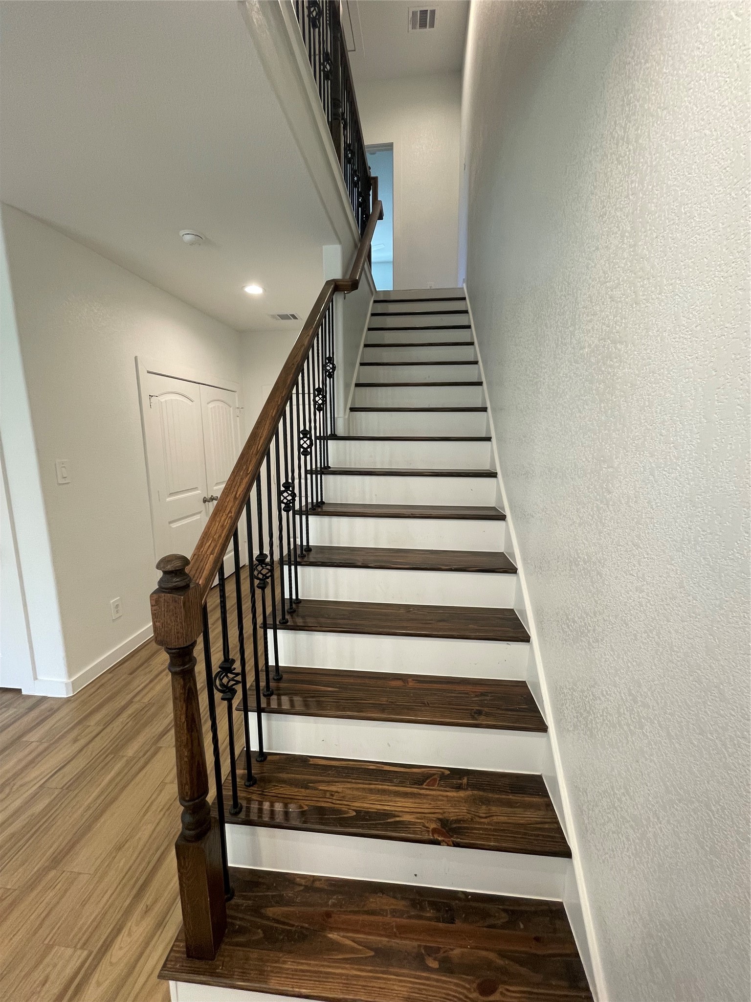 5314 Longmeadow Street, Unit B Houston, TX 77033 - Photo 12 of 32 Staircase with beautiful wroth iron railing