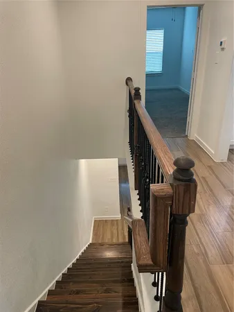 a view of entryway and hall with wooden floor