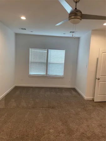 an empty room with a empty space and windows