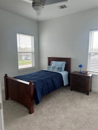 a bedroom with bed and window