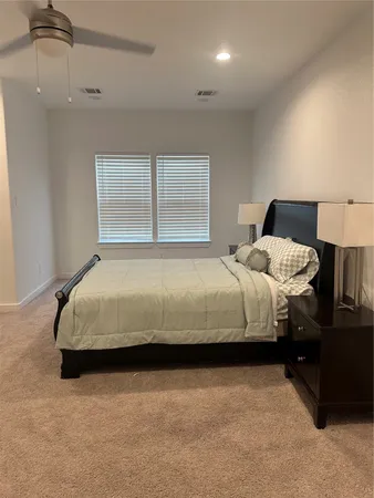 a bedroom with a bed and a night stand