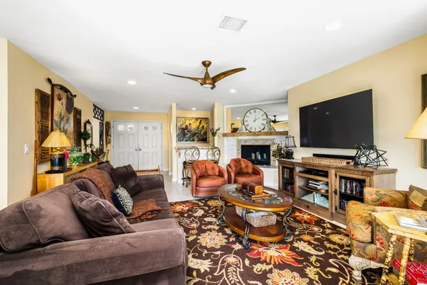 a living room with fireplace furniture and a flat screen tv