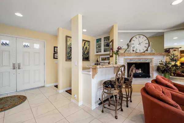 a living room with furniture and a shelf