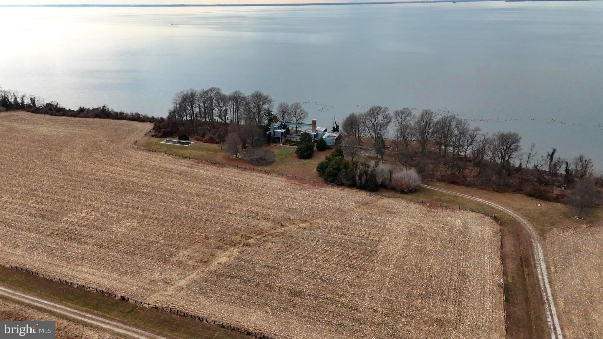 6520 Swan Creek Road Rock Hall, MD 21661 - Photo 11 of 62 a bed with white sheets and a blanket