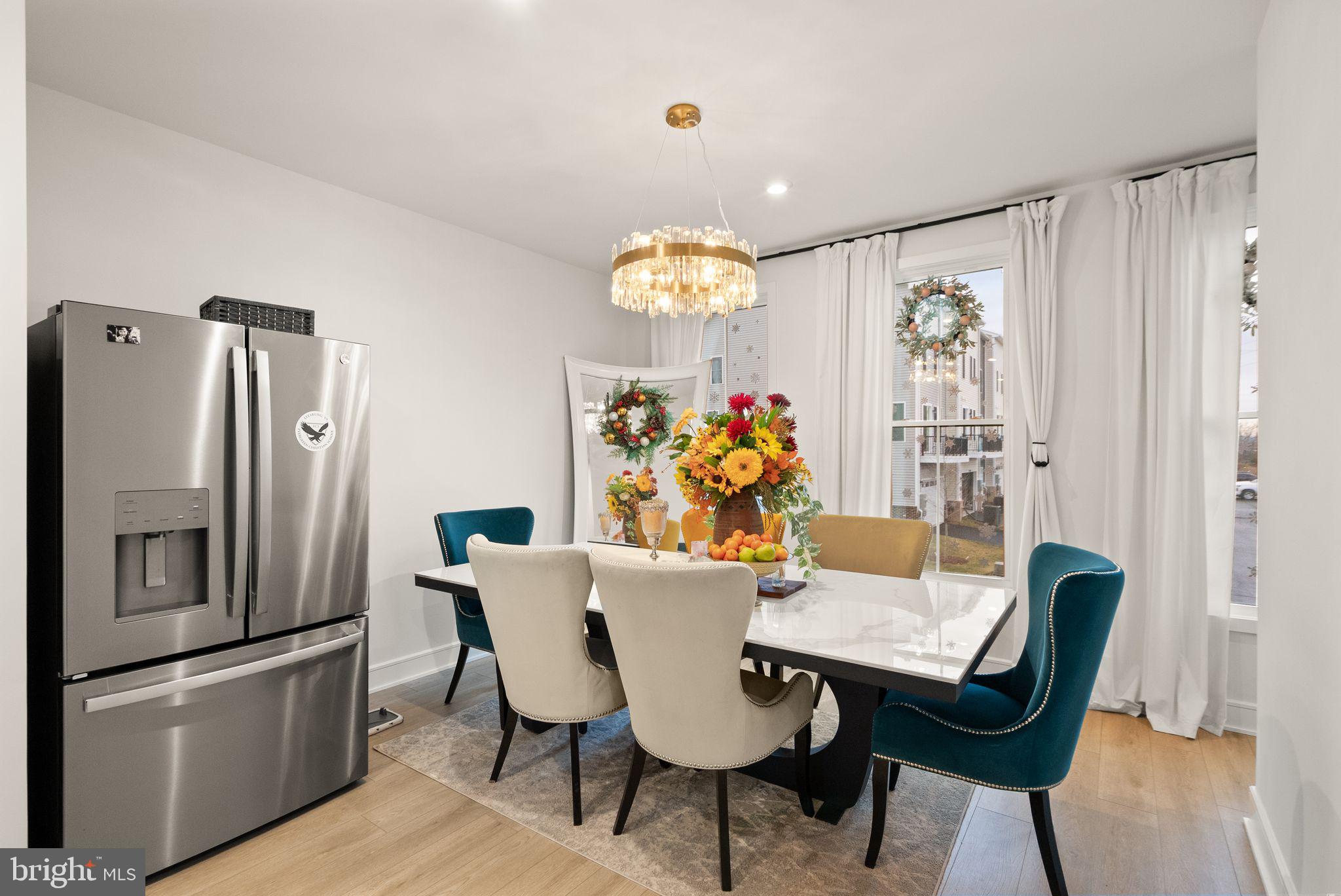 23062 Copper Tree Terrace Ashburn, VA 20148 - Photo 12 of 38 a view of a dining room with furniture and chandelier