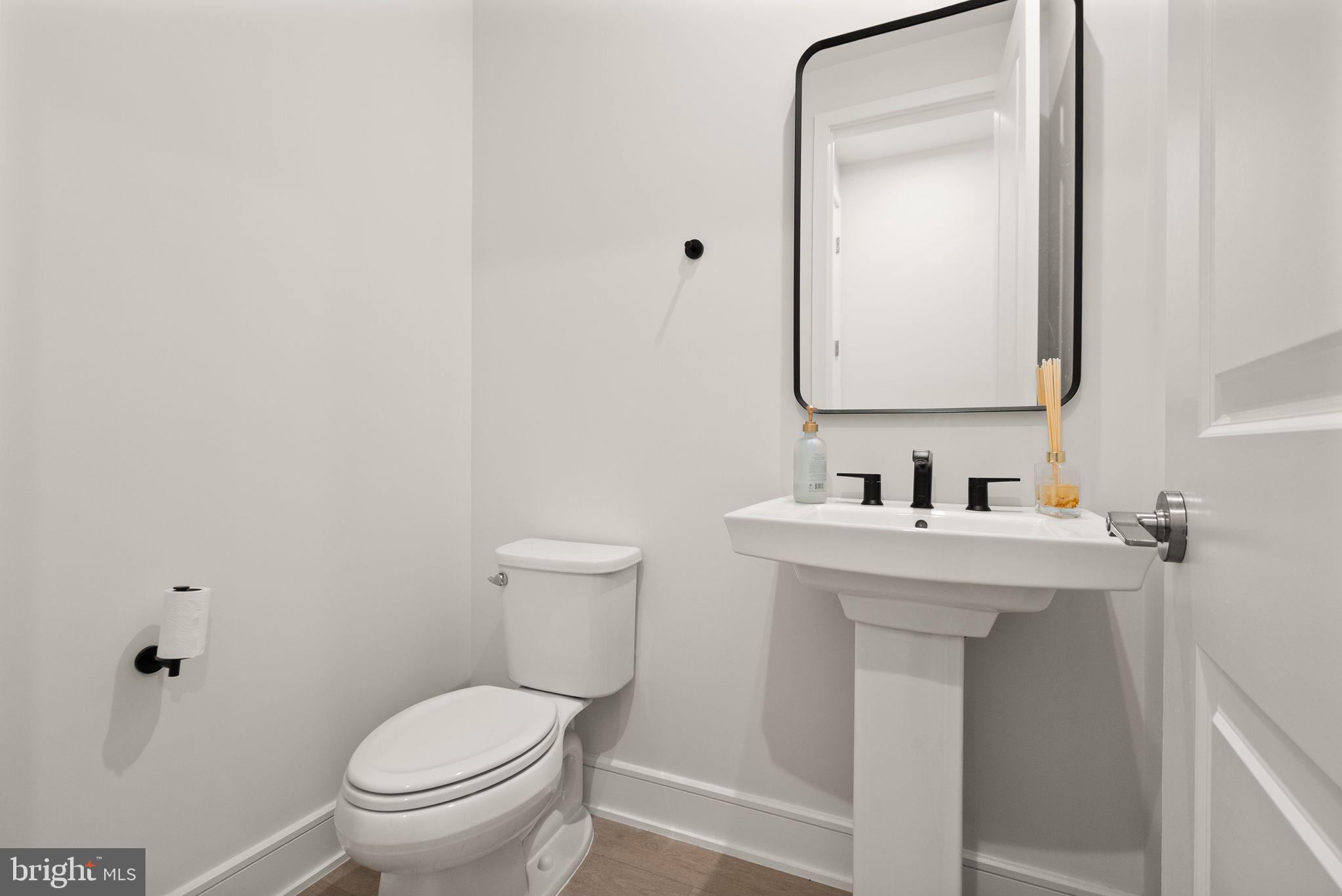 23062 Copper Tree Terrace Ashburn, VA 20148 - Photo 15 of 38 a bathroom with a toilet sink and mirror