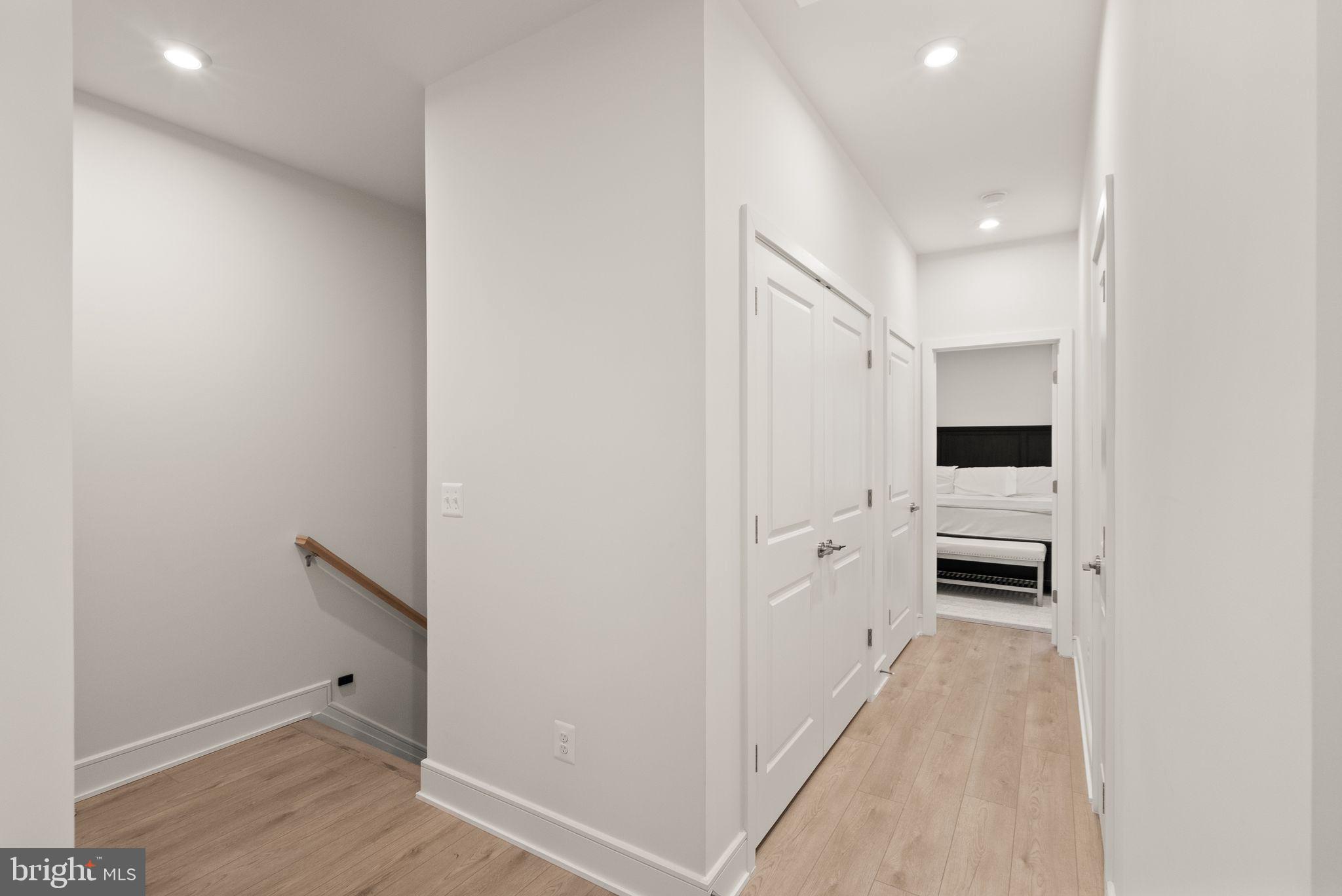 23062 Copper Tree Terrace Ashburn, VA 20148 - Photo 16 of 38 a hallway with white wooden cabinets