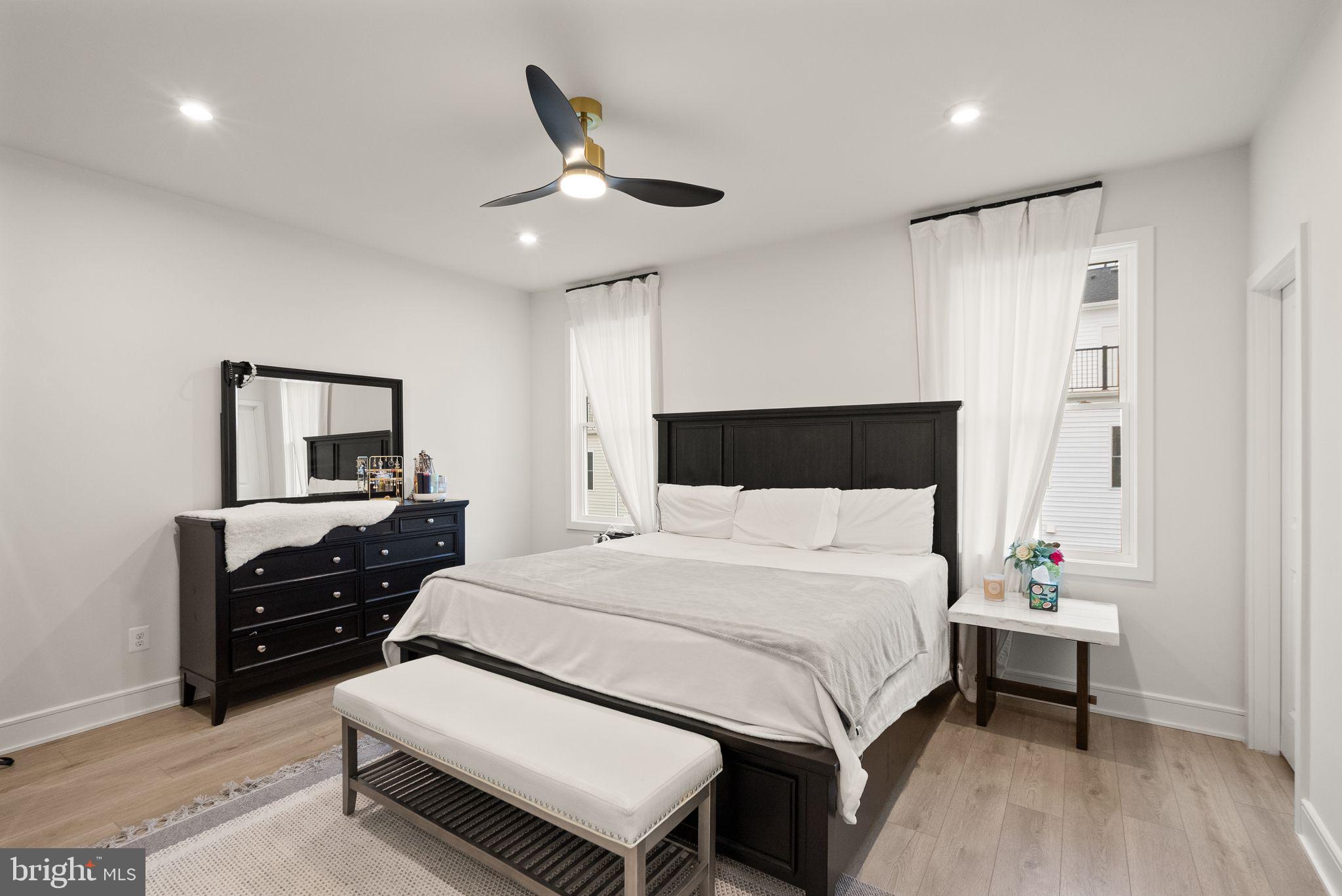 23062 Copper Tree Terrace Ashburn, VA 20148 - Photo 17 of 38 a bedroom with a bed and a chandelier