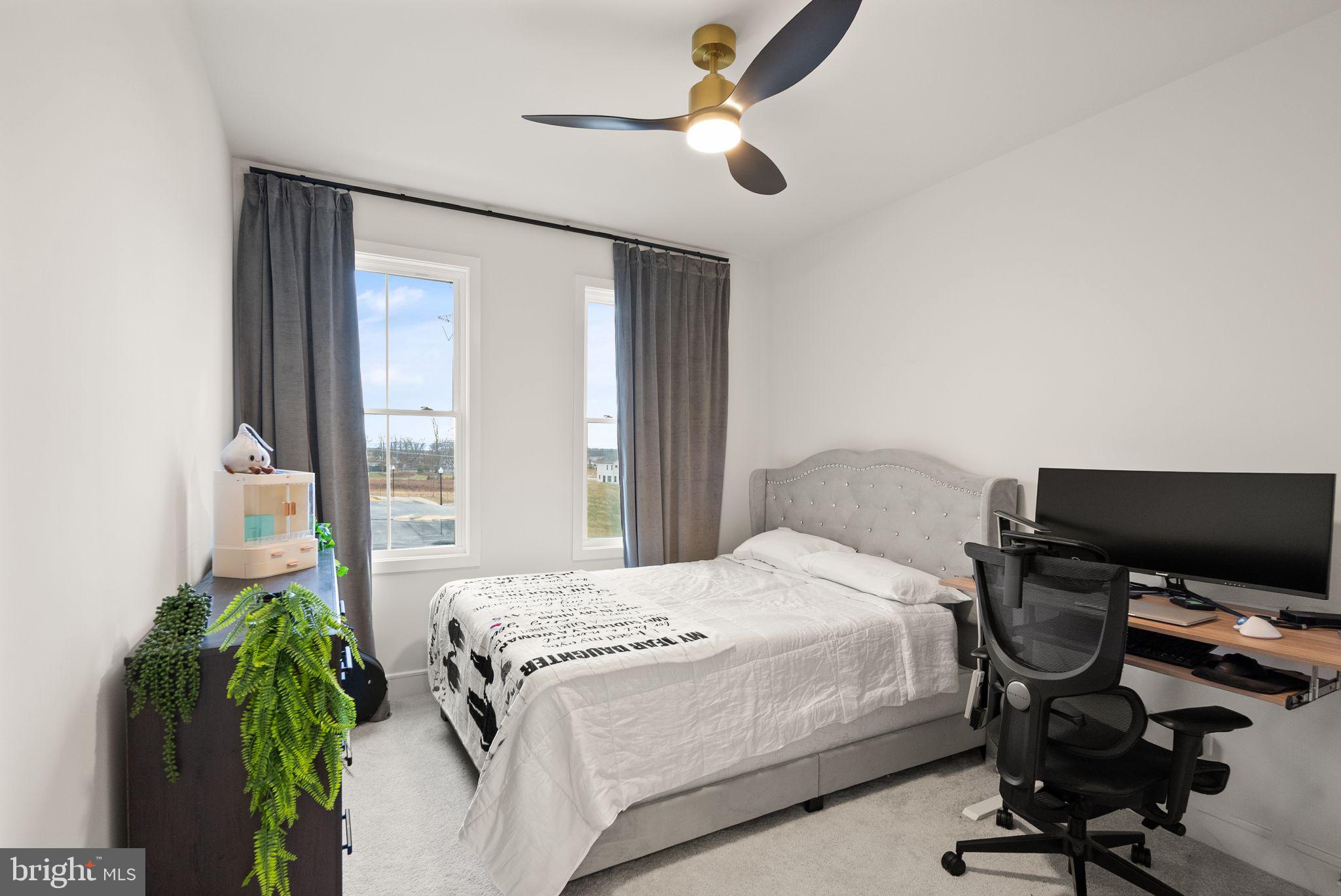 23062 Copper Tree Terrace Ashburn, VA 20148 - Photo 21 of 38 a bedroom with a bed and a chandelier