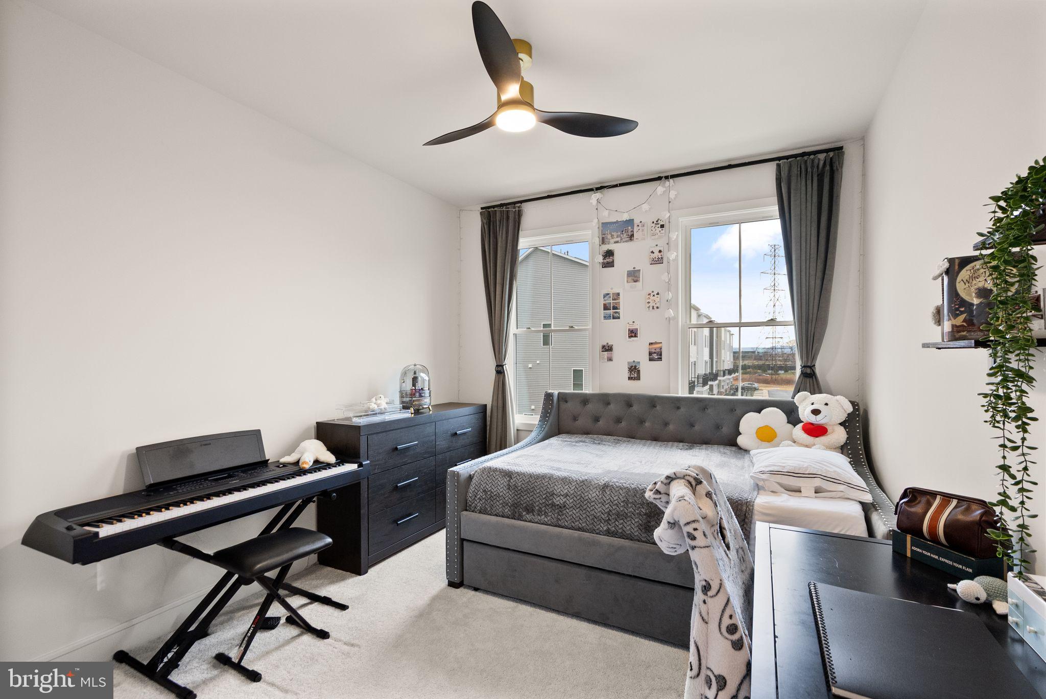 23062 Copper Tree Terrace Ashburn, VA 20148 - Photo 23 of 38 a bedroom with a bed and a desk