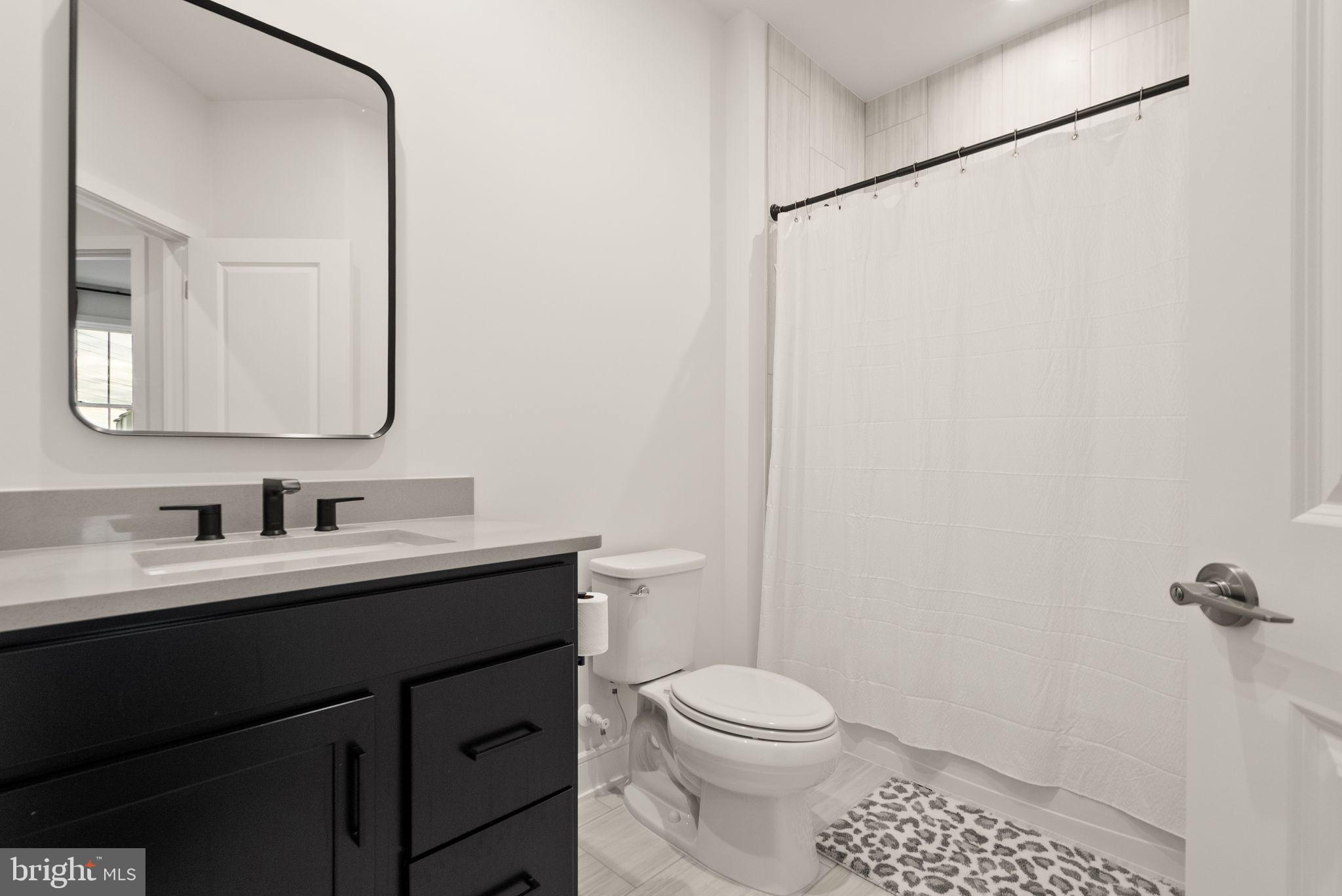 23062 Copper Tree Terrace Ashburn, VA 20148 - Photo 25 of 38 a bathroom with a toilet a sink a vanity and mirror