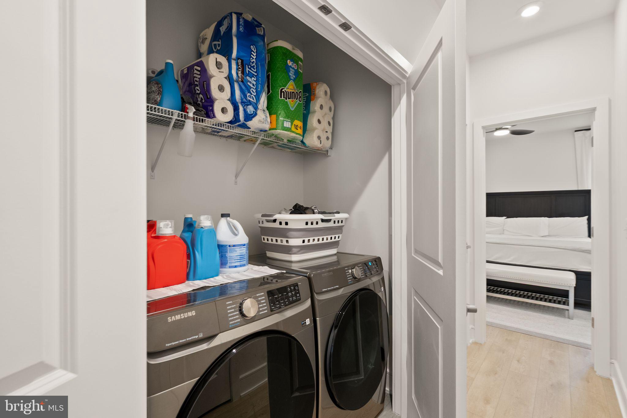 23062 Copper Tree Terrace Ashburn, VA 20148 - Photo 26 of 38 a utility room with dryer washer and a view of living room