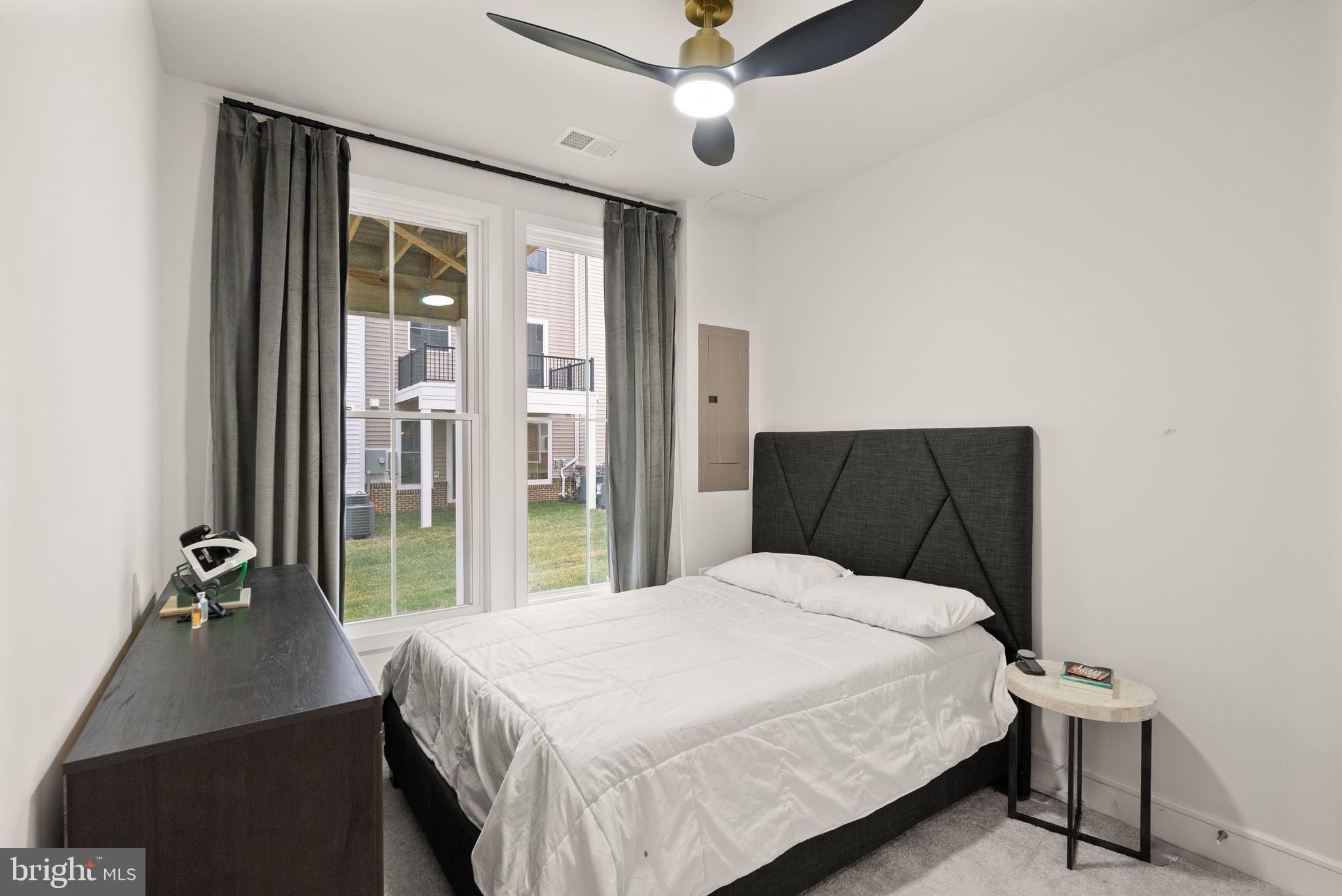 23062 Copper Tree Terrace Ashburn, VA 20148 - Photo 29 of 38 a bedroom with a bed and a table