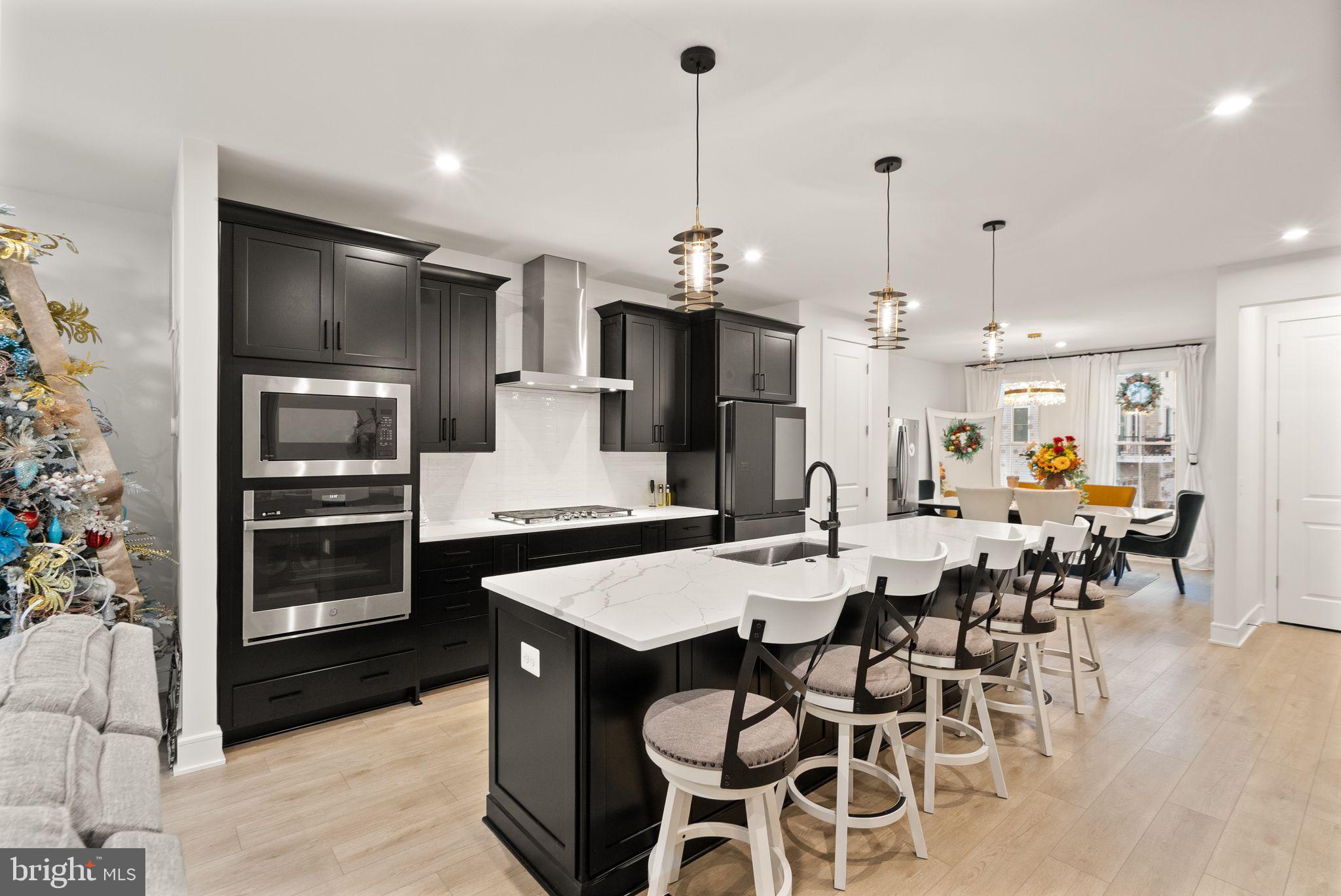 23062 Copper Tree Terrace Ashburn, VA 20148 - Photo 4 of 38 a large kitchen with a table and chairs