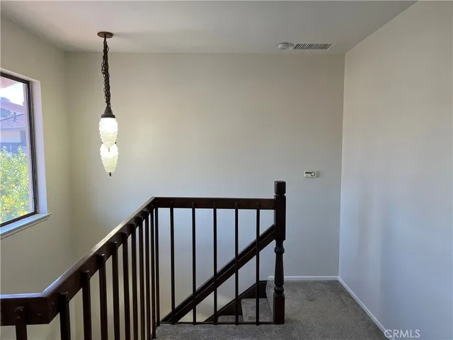 an empty room with windows and entrance