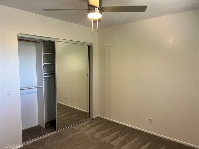 a view of a chair and table in the backyard