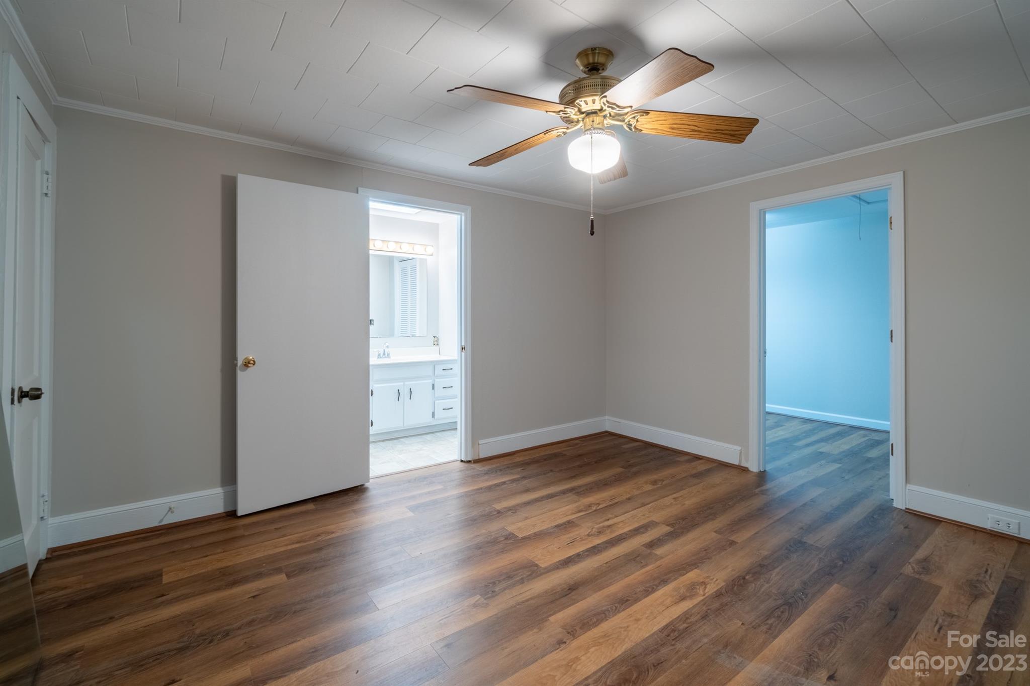 17158 Pond Road Locust, NC 28097 - Photo 15 of 28 an empty room with wooden floor and ceiling fan